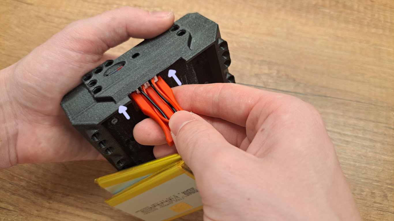 Insert the battery removal tool
